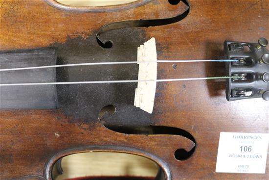 A cased violin bearing Cremoneous label and two bows